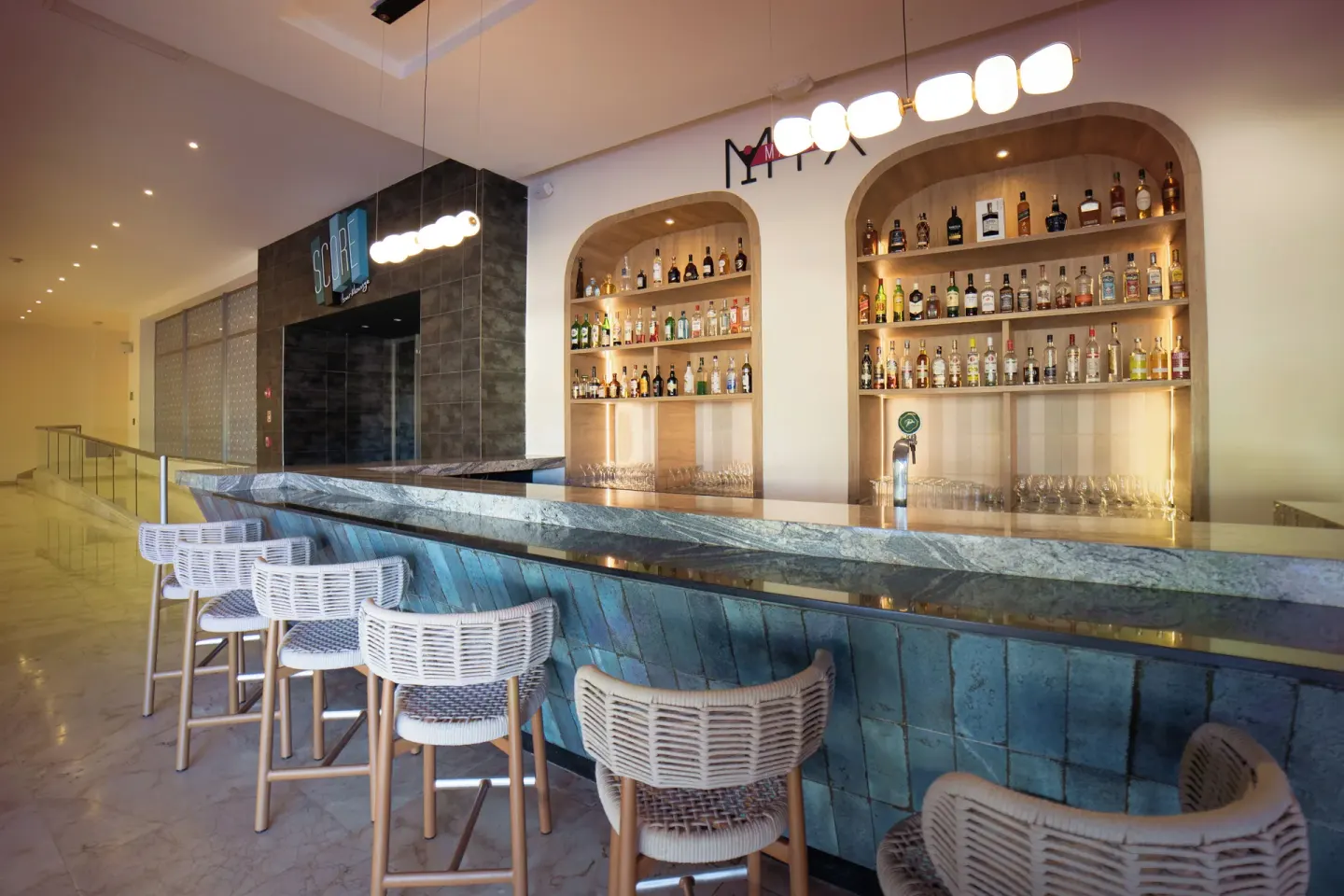 Martini Mix bar with stools and backlit bottles at Royalton Hideaway Punta Cana Resort & Casino.