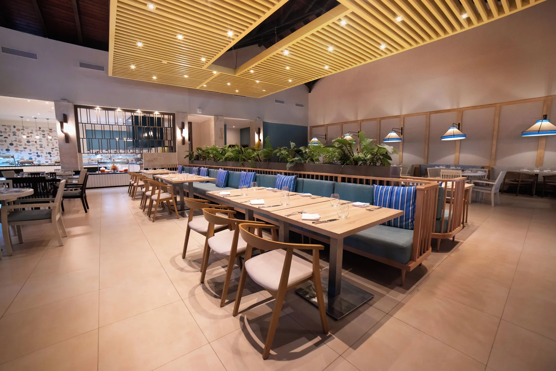 Modern dining room with blue banquettes at Royalton Hideaway Punta Cana Resort & Casino.