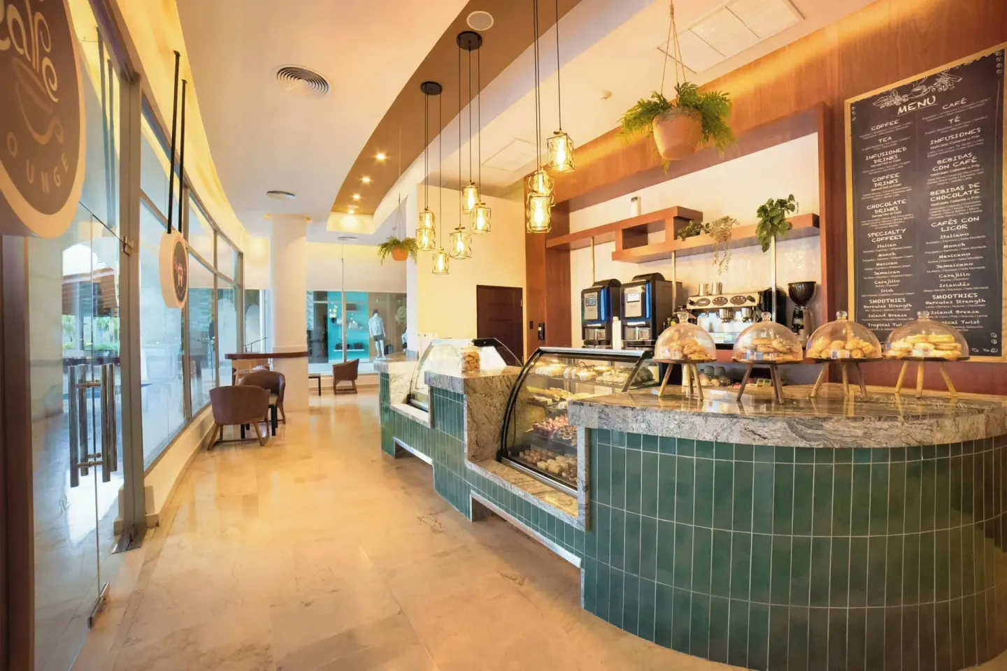 Cafe counter with pastry cases and menu boards at Royalton Hideaway Punta Cana Resort & Casino.