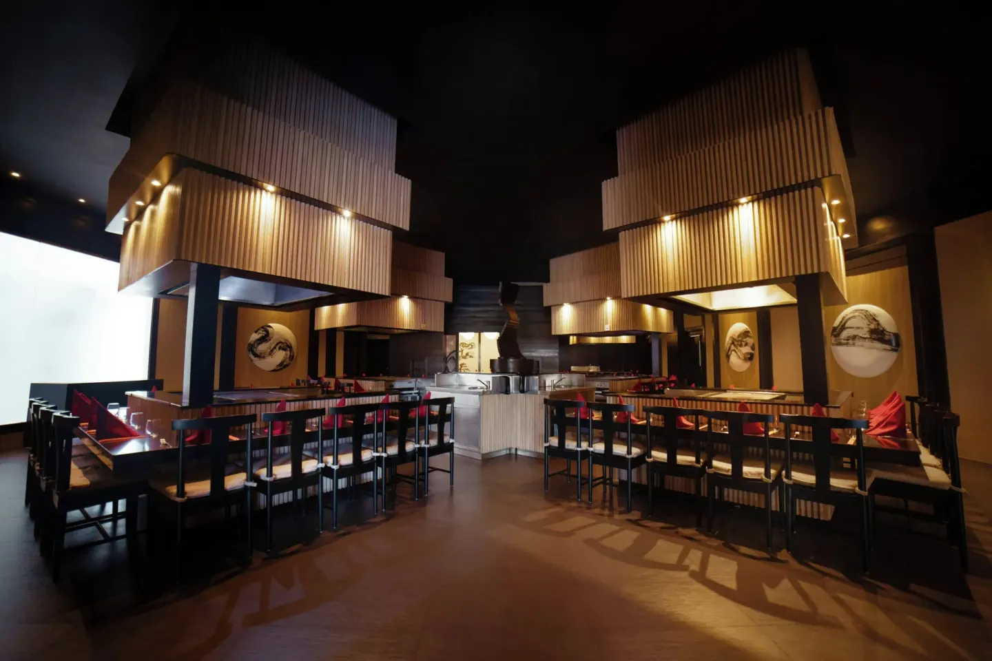 Dark hibachi-style dining room with grill stations at Royalton Hideaway Punta Cana Resort & Casino.