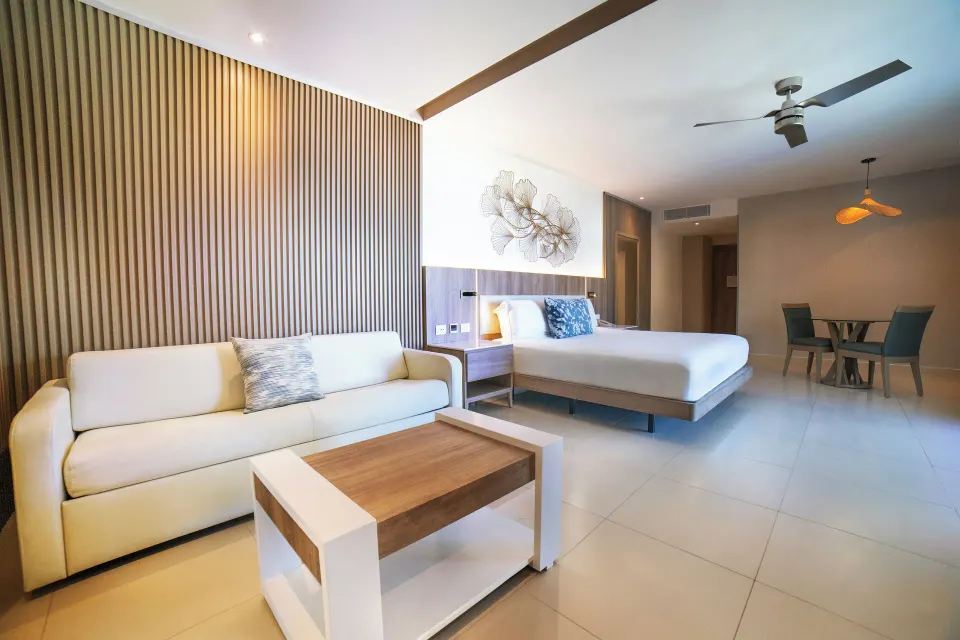 Honeymoon Jacuzzi Suite Diamond Club at Royalton Hideaway Punta Cana Resort & Casino with sofa, coffee table, king bed, and d