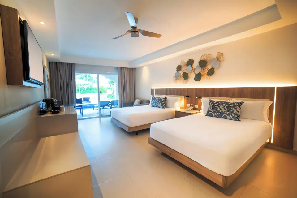Luxury Room with two beds and balcony doors at Royalton Hideaway Punta Cana Resort & Casino.