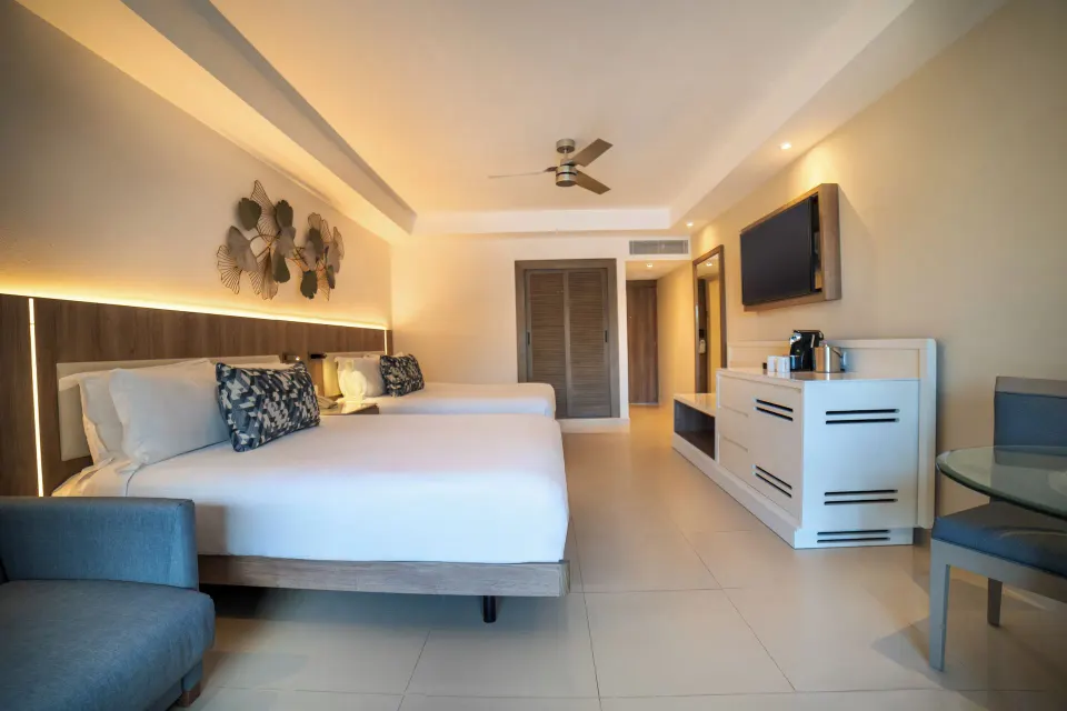 Luxury Room with two beds, TV, and coffee station at Royalton Hideaway Punta Cana Resort & Casino.