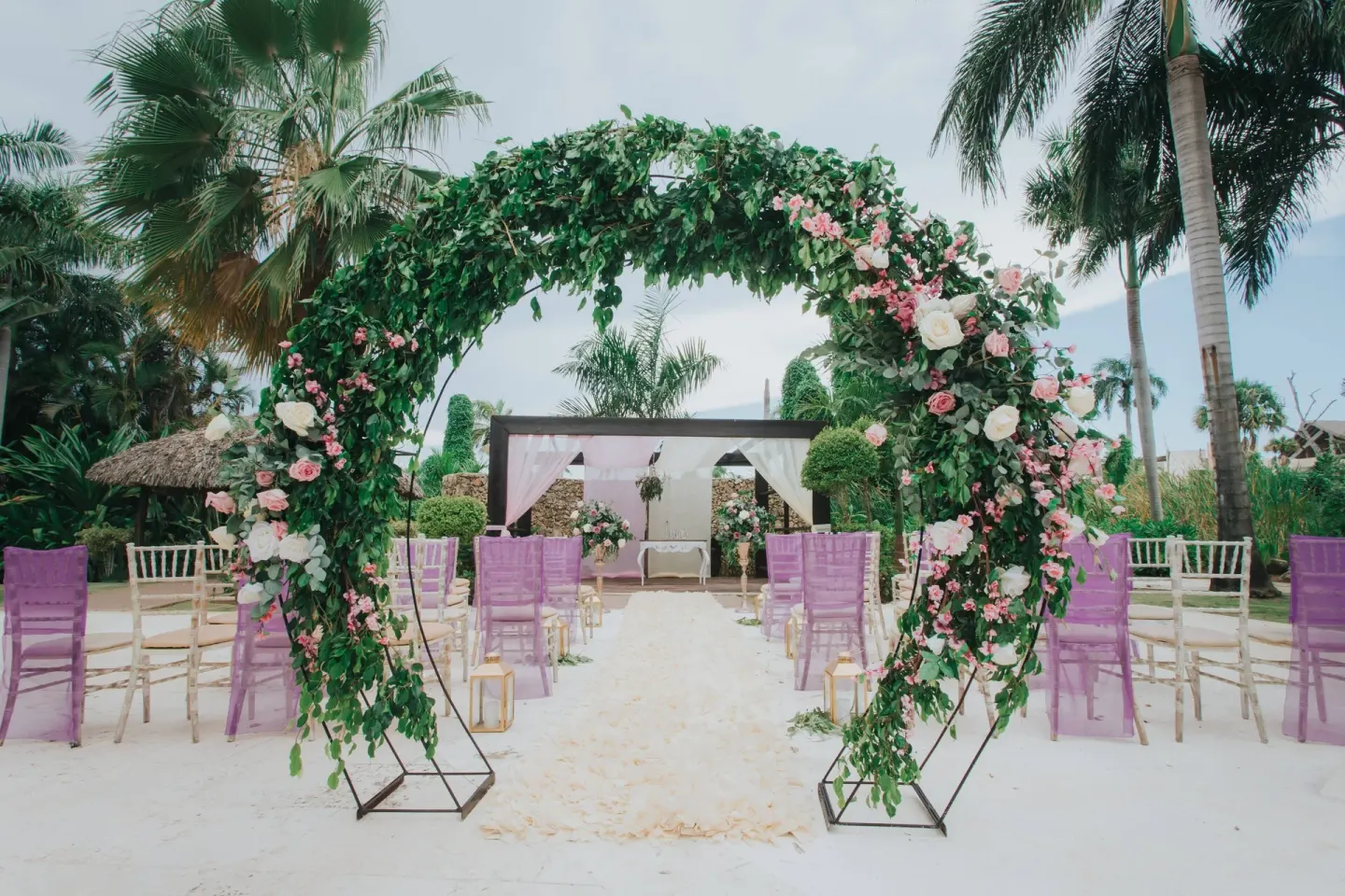Beach wedding aisle with floral arch at Royalton Hideaway Punta Cana Resort & Casino.