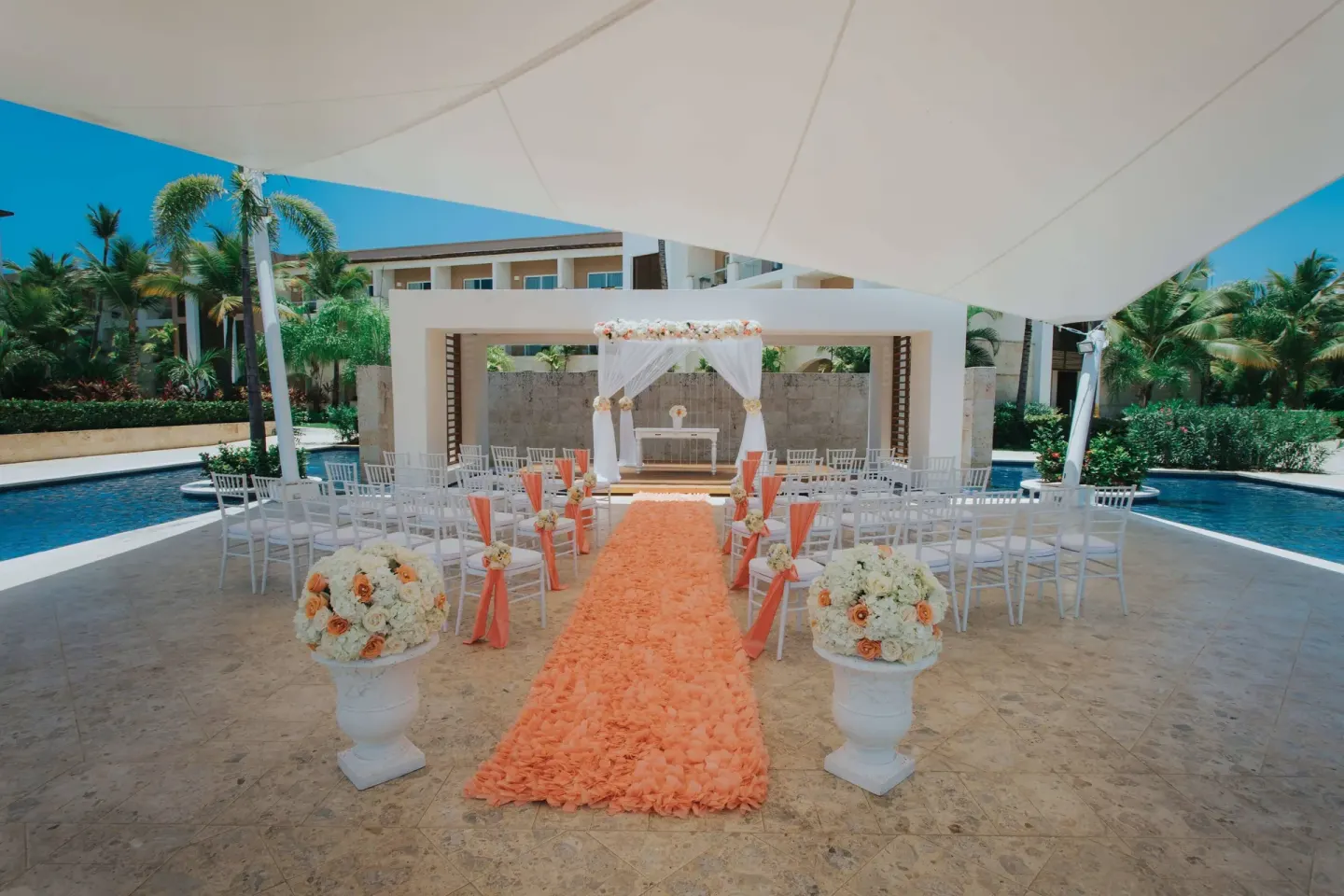 Outdoor wedding setup with white chairs at Royalton Hideaway Punta Cana Resort & Casino.