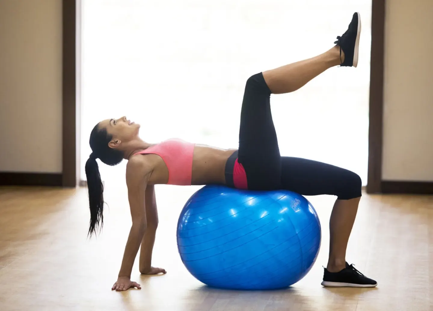 Woman exercising on a blue stability ball at Royalton Hideaway Saint Lucia.