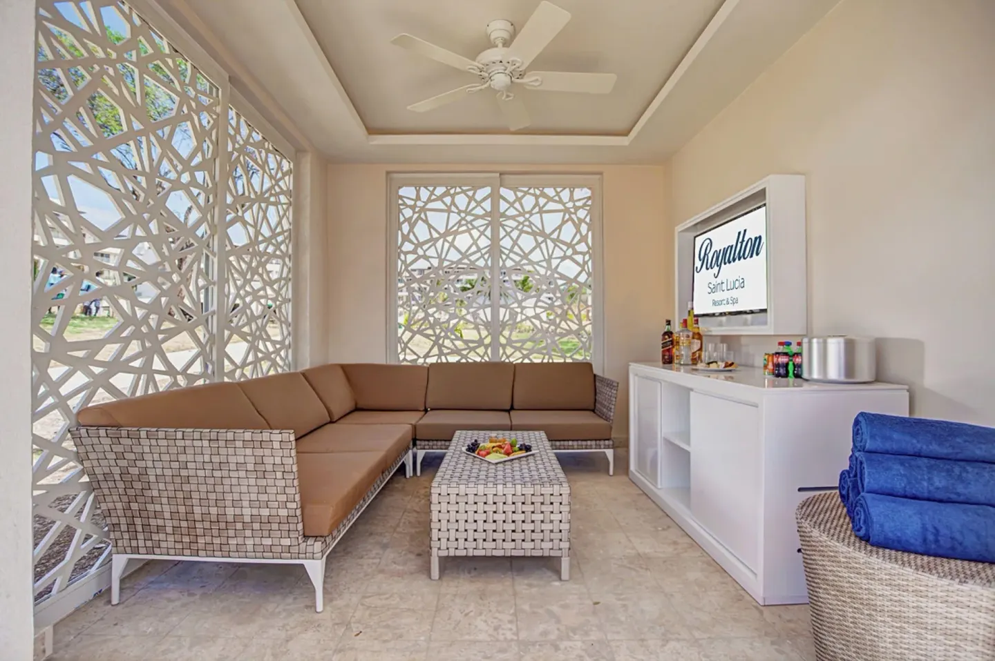 Shaded poolside cabana with sofa seating and towels at Royalton Hideaway Saint Lucia.