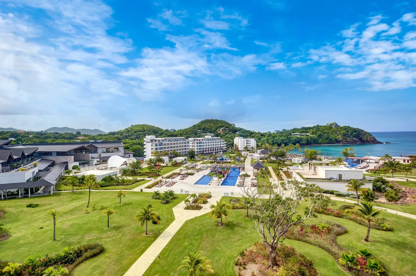 Wide resort grounds with lawns, pools, buildings, and coastline at Royalton Hideaway Saint Lucia.