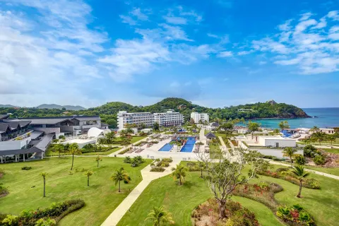 Wide resort grounds with lawns, pools, buildings, and coastline at Royalton Hideaway Saint Lucia.