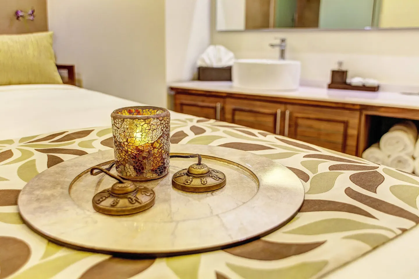 Candle tray on a spa treatment bed with vanity in the background at Royalton Hideaway Saint Lucia.