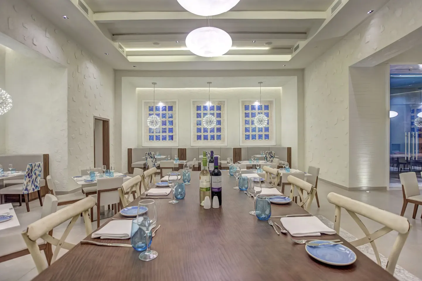 Bright restaurant dining room with a long set table at Royalton Hideaway Saint Lucia.