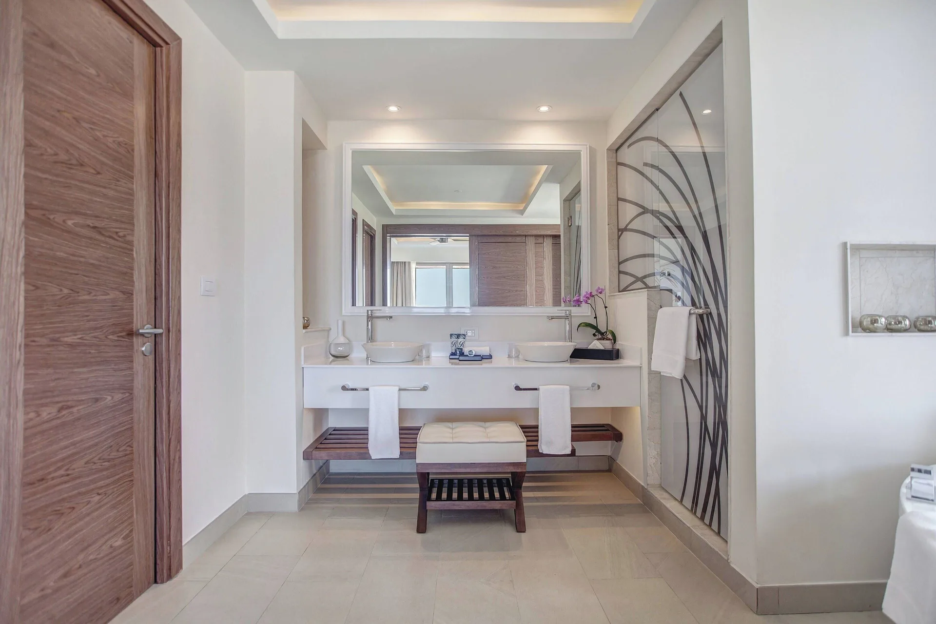 Bathroom vanity with two sinks and glass shower at Royalton Hideaway Saint Lucia.