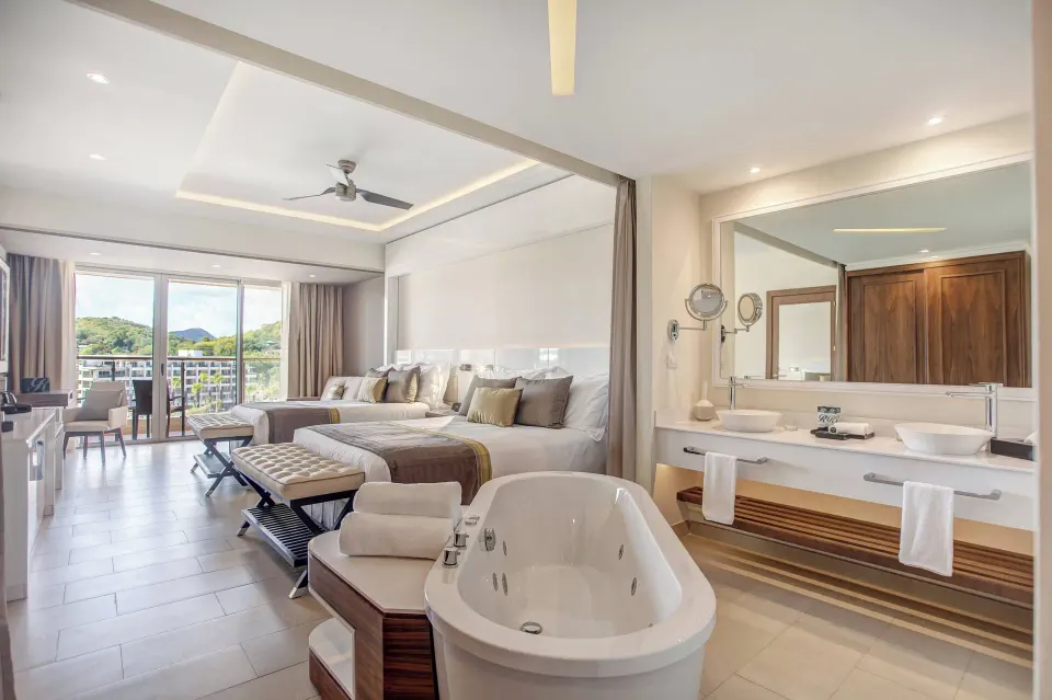 Junior suite with two beds, freestanding tub and double vanity at Royalton Hideaway Saint Lucia.