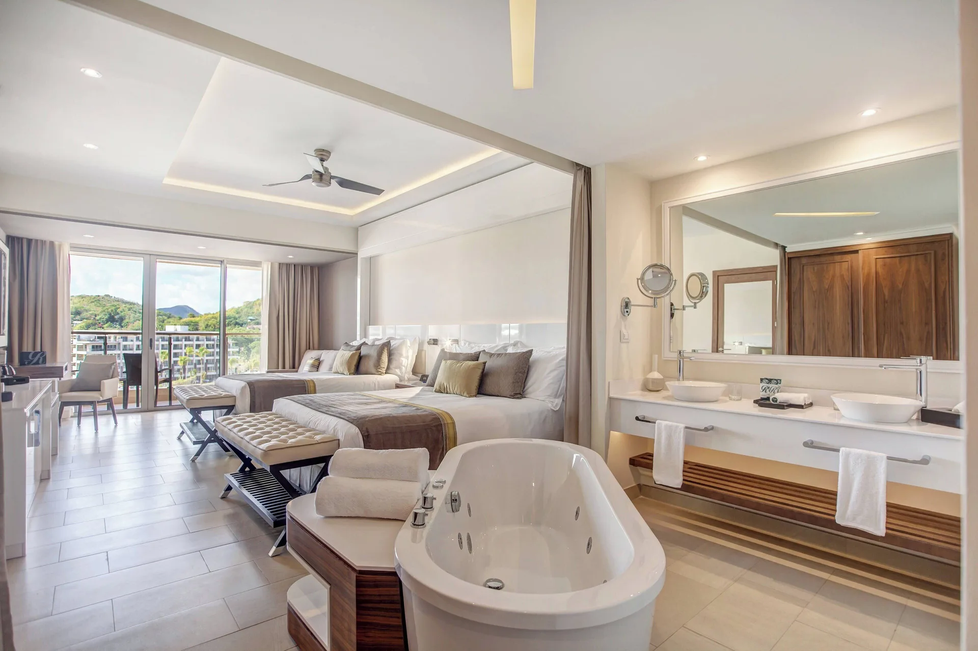 Junior suite with two beds, freestanding tub and double vanity at Royalton Hideaway Saint Lucia.