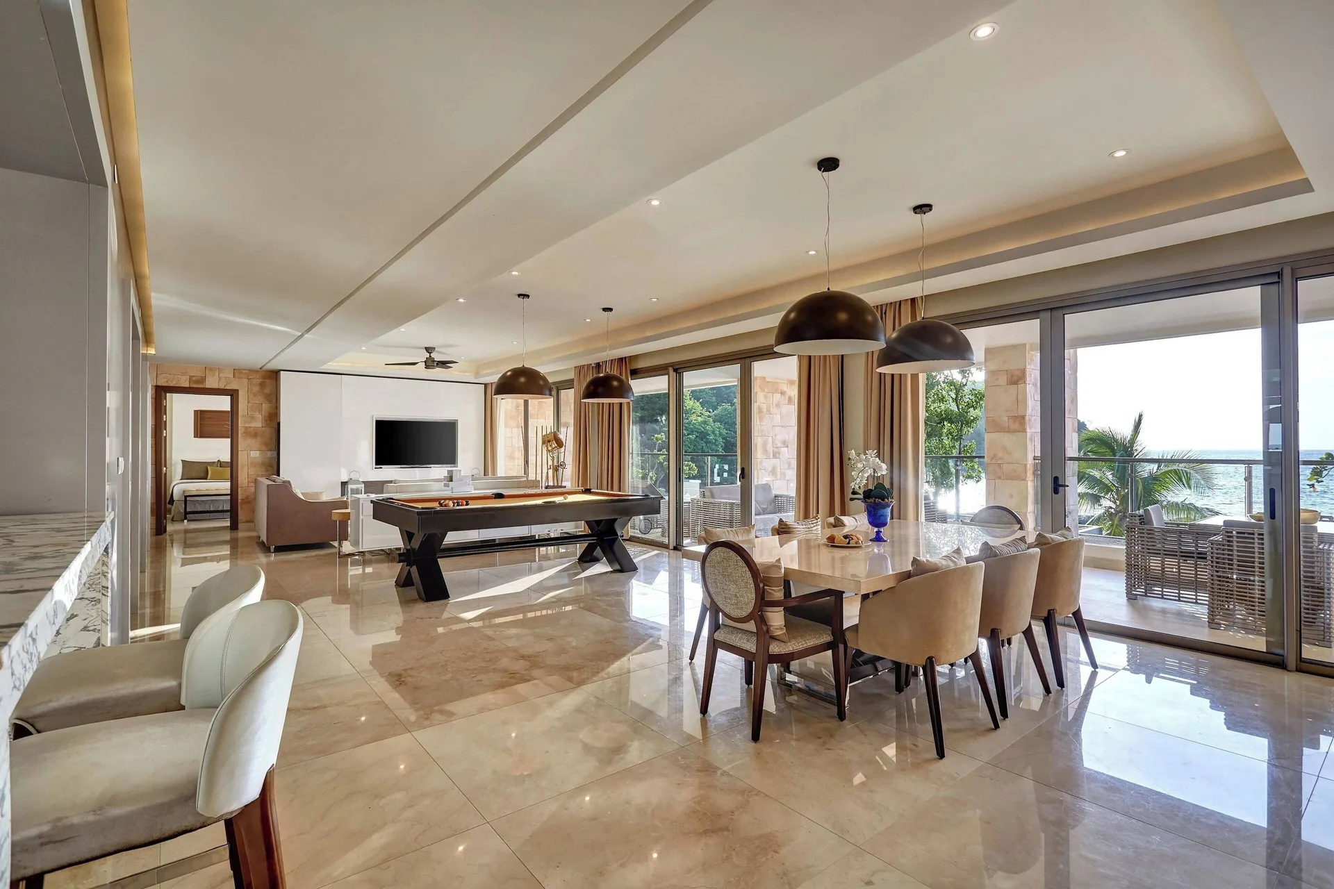 Open suite dining and game area with ocean balcony at Royalton Hideaway Saint Lucia.