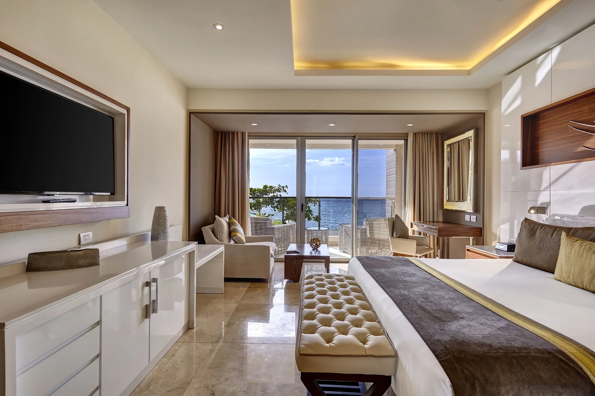 King bedroom with seating area and ocean balcony at Royalton Hideaway Saint Lucia.
