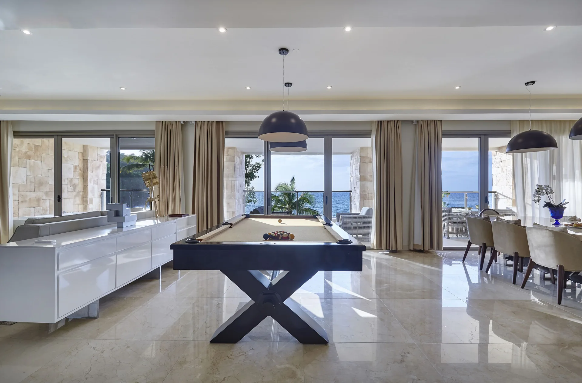 Open suite lounge with pool table and ocean-facing balconies at Royalton Hideaway Saint Lucia.