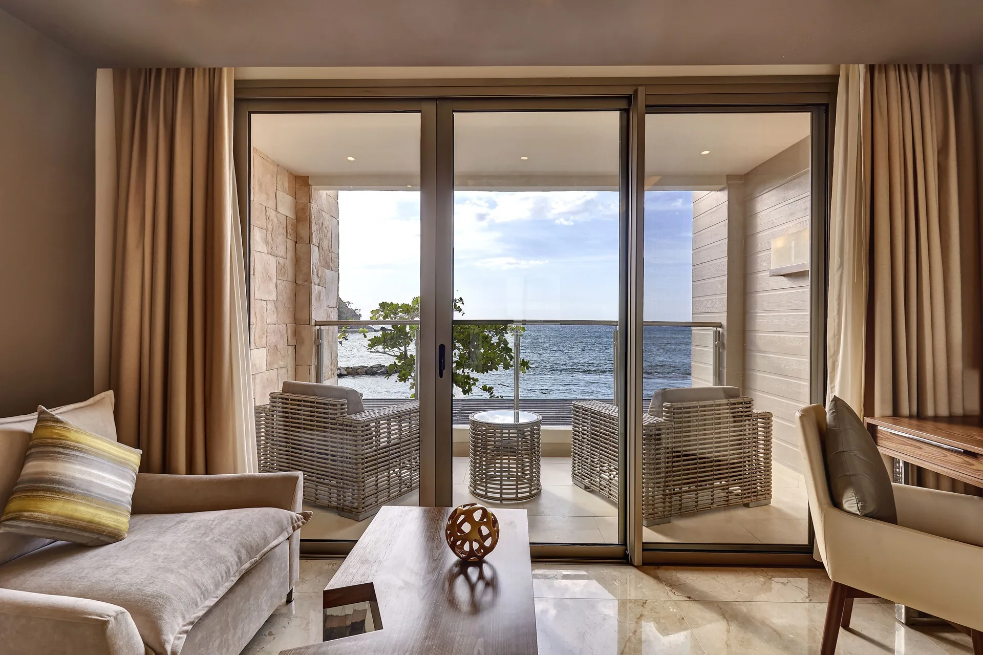 Sitting area looking onto an oceanfront balcony at Royalton Hideaway Saint Lucia.