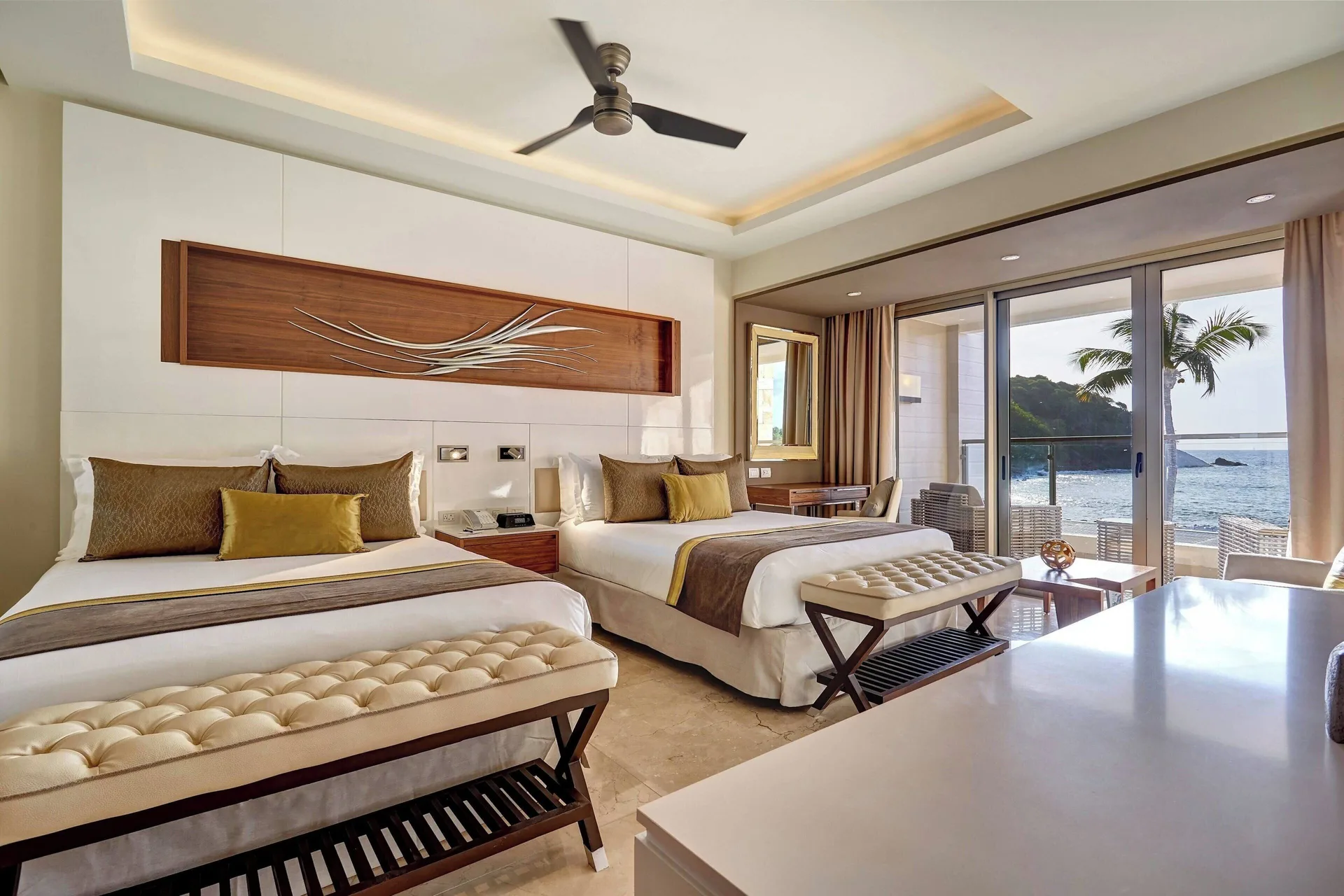 Bedroom with two beds and ocean-facing balcony at Royalton Hideaway Saint Lucia.