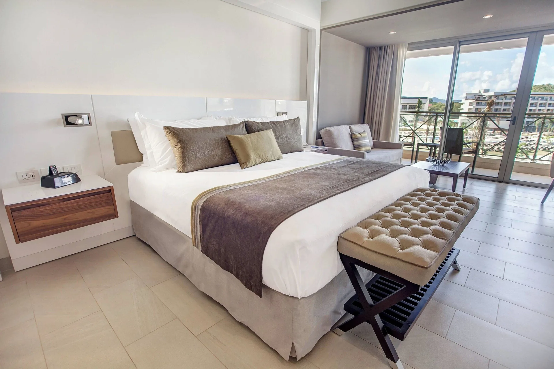 Luxury Family Suite Ocean View Diamond Club king bed and sitting area at Royalton Hideaway Saint Lucia.