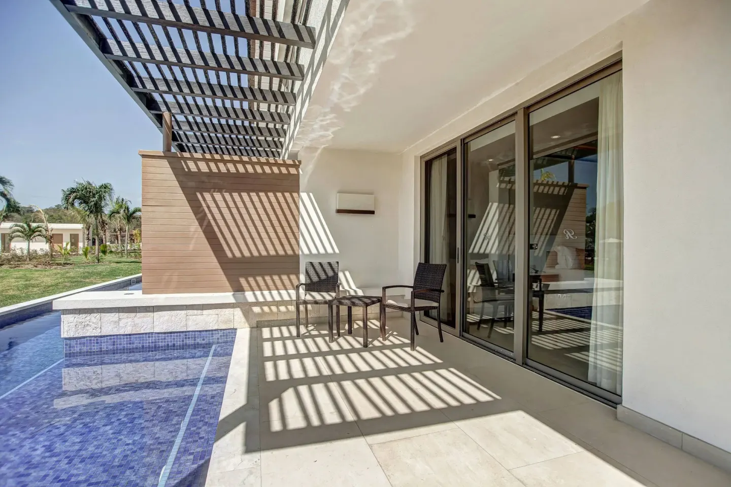 Covered swim-out terrace with chairs and pool at Royalton Hideaway Saint Lucia.