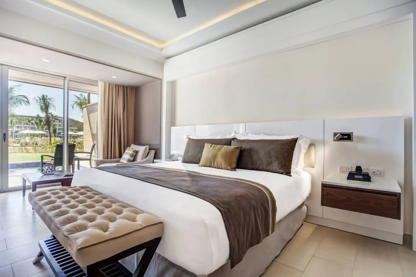 King bed and patio doors in a Luxury Junior Suite Swim Out at Royalton Hideaway Saint Lucia.