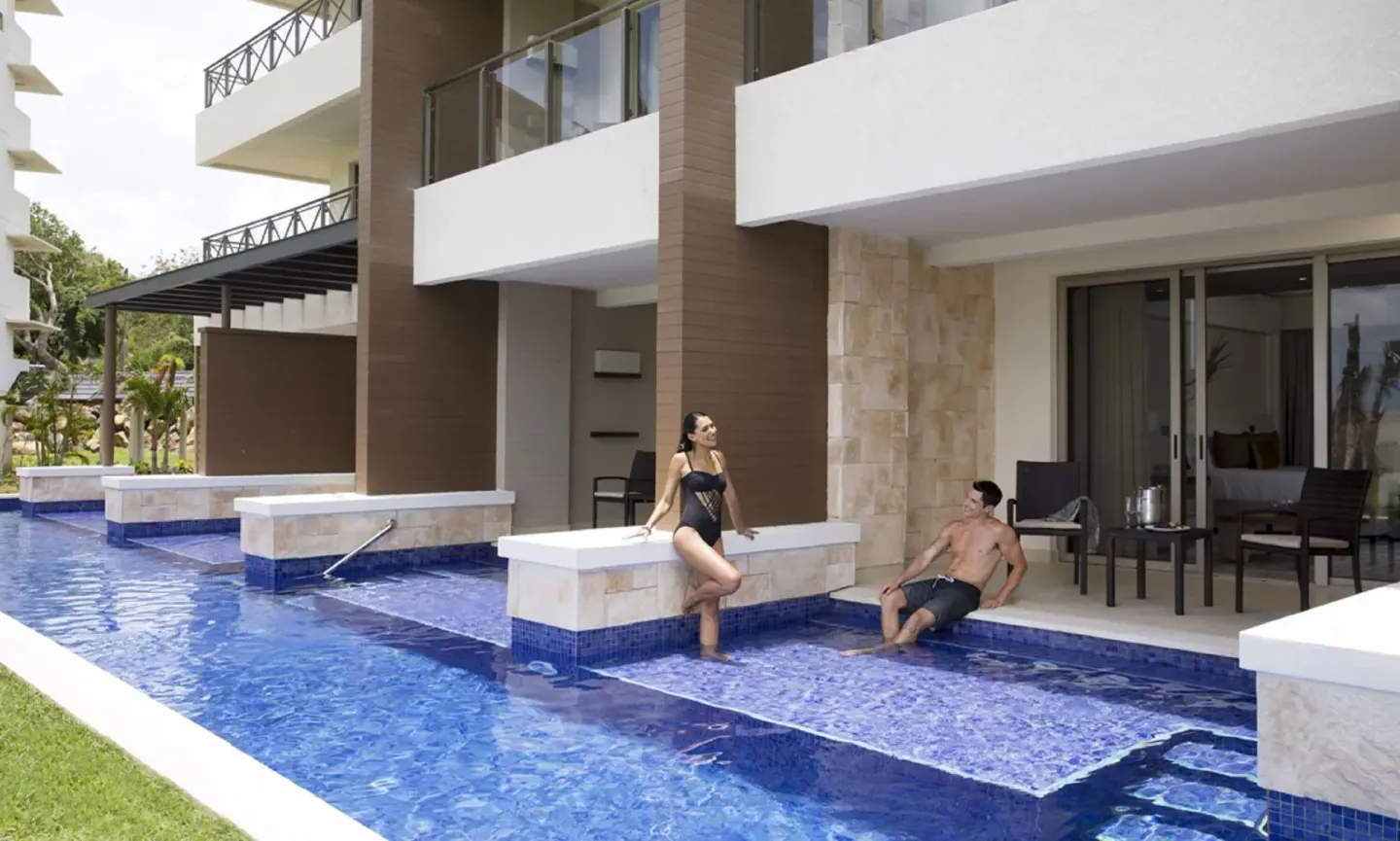 Swim-out suite patio with guests beside the pool at Royalton Hideaway Saint Lucia.