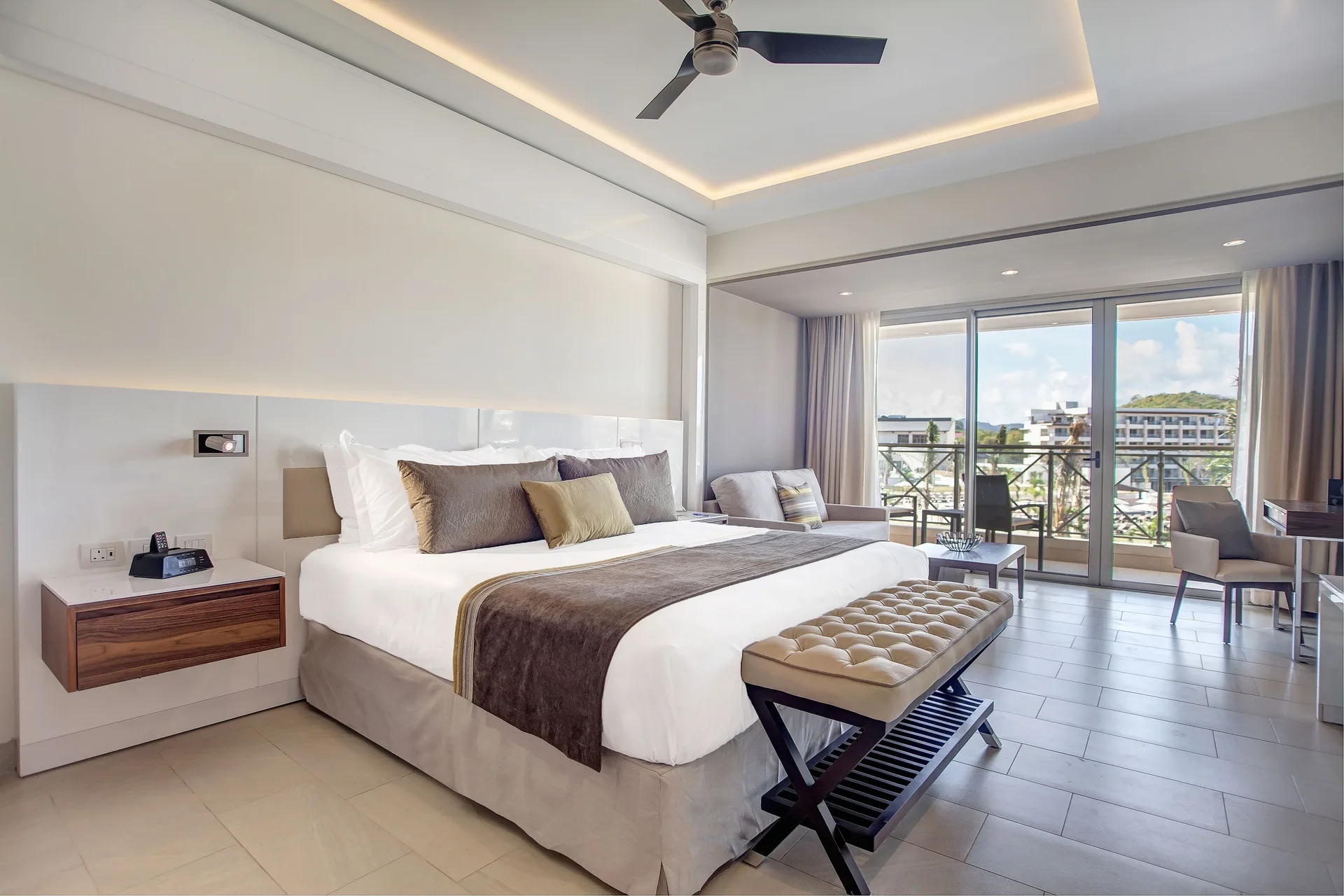 Luxury Junior Suite king bed with balcony seating at Royalton Hideaway Saint Lucia.