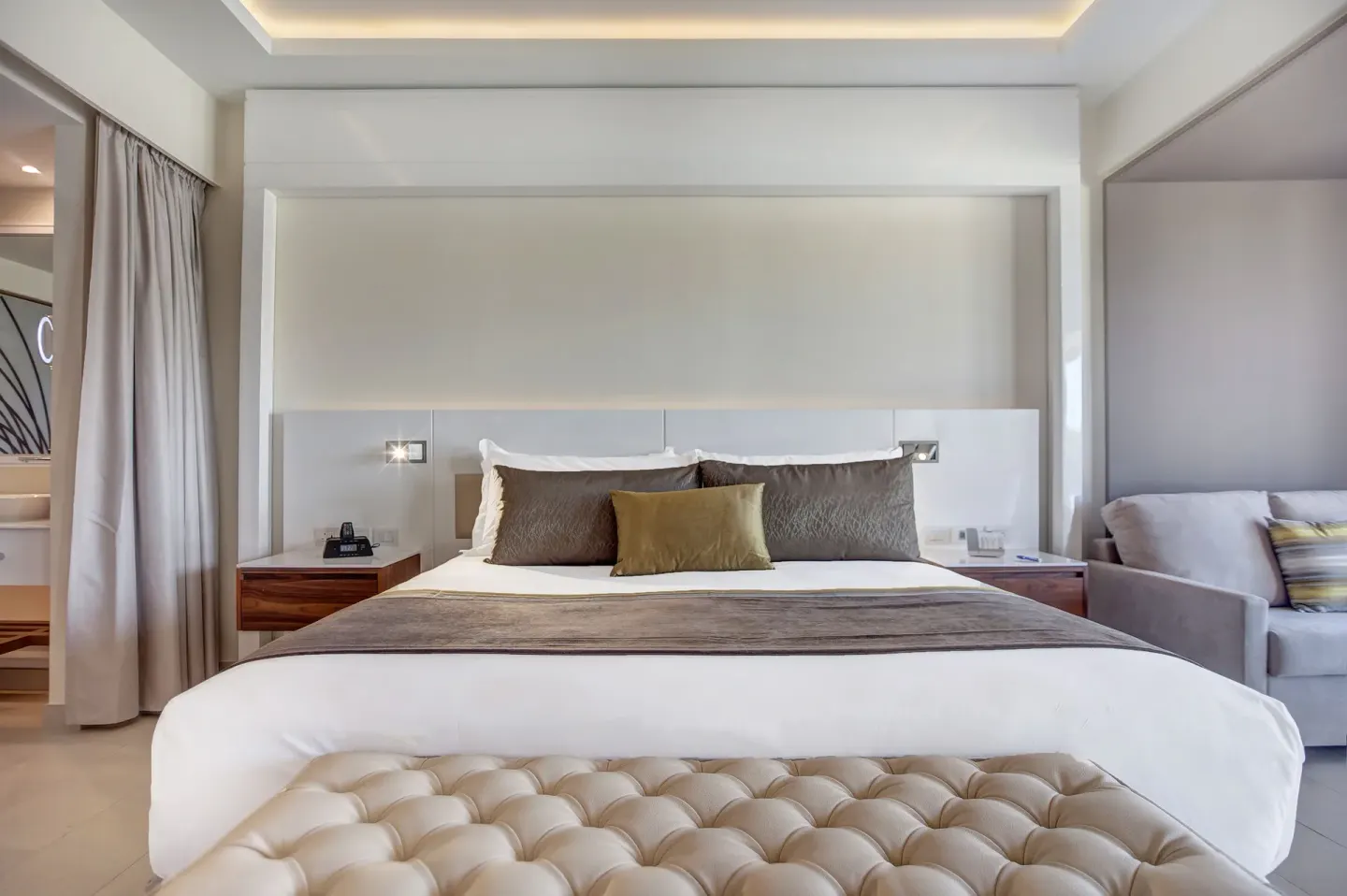 Luxury Junior Suite king bed with tufted bench at Royalton Hideaway Saint Lucia.