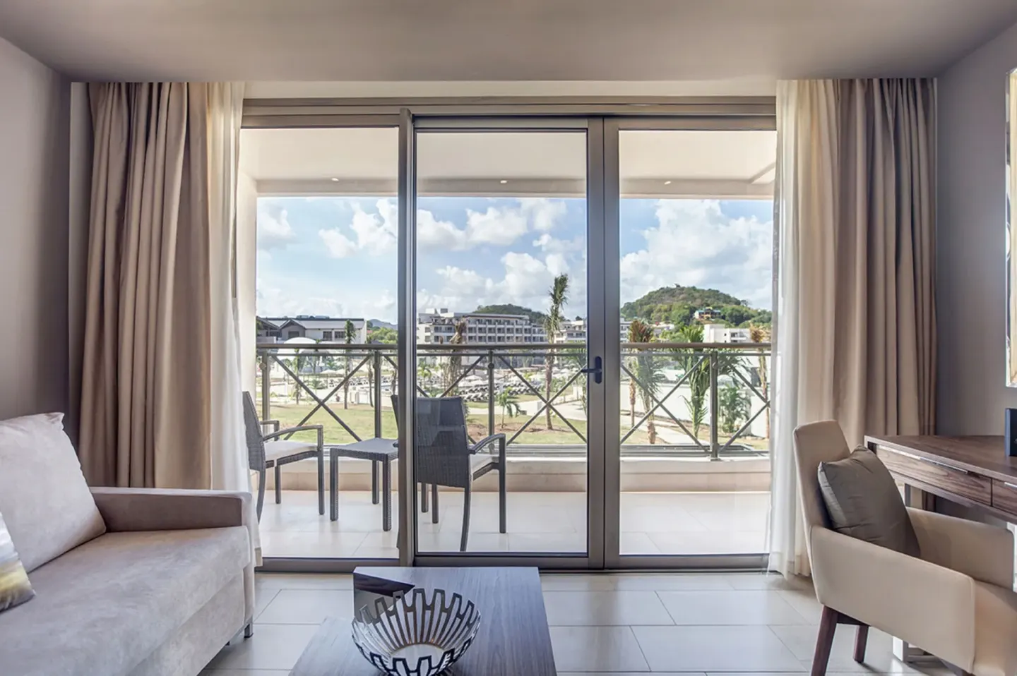 Luxury Junior Suite sitting area and balcony doors at Royalton Hideaway Saint Lucia.