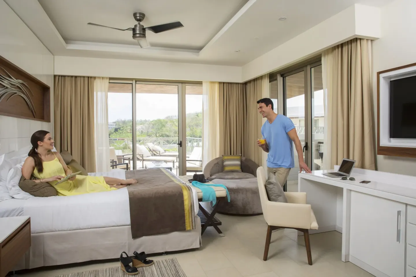 King bed guest room with desk and terrace doors at Royalton Hideaway Saint Lucia.