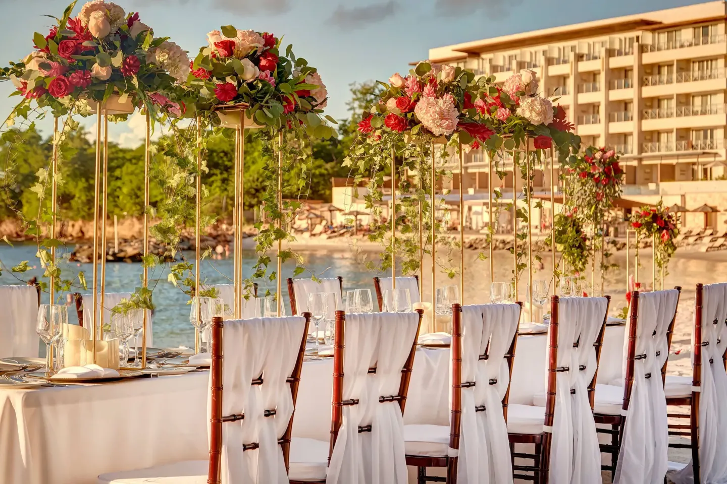 Beachfront wedding reception tables with floral centerpieces at Royalton Hideaway Saint Lucia.