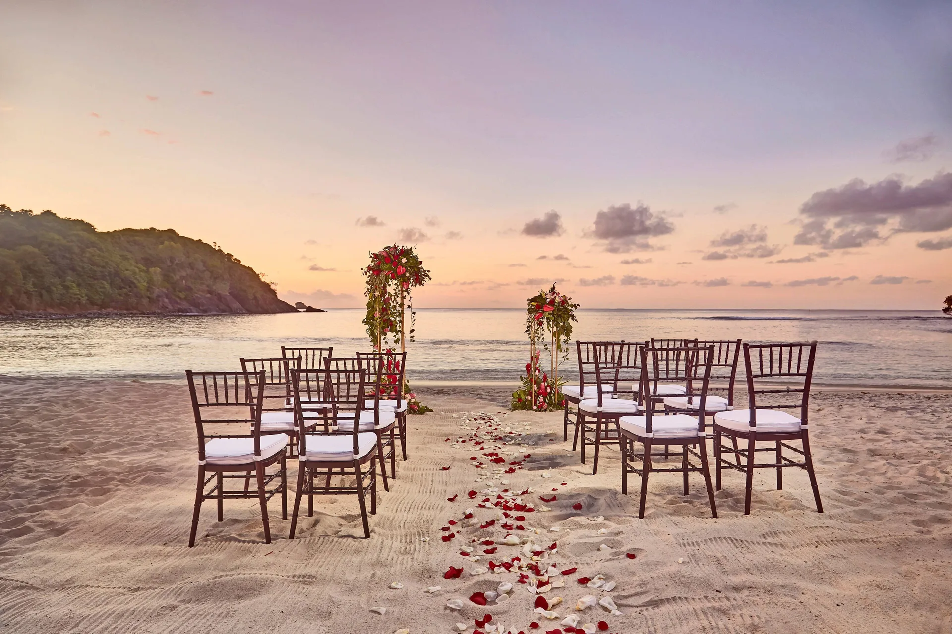 Sunset beach wedding ceremony chairs facing the ocean at Royalton Hideaway Saint Lucia.