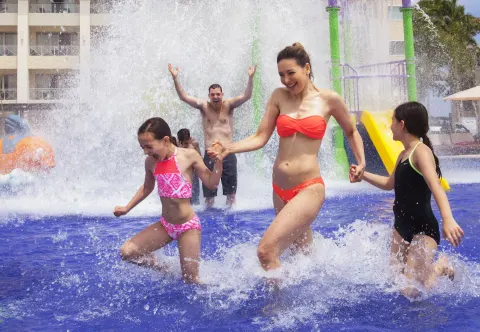 Family splashing in the water play area at Royalton Negril.