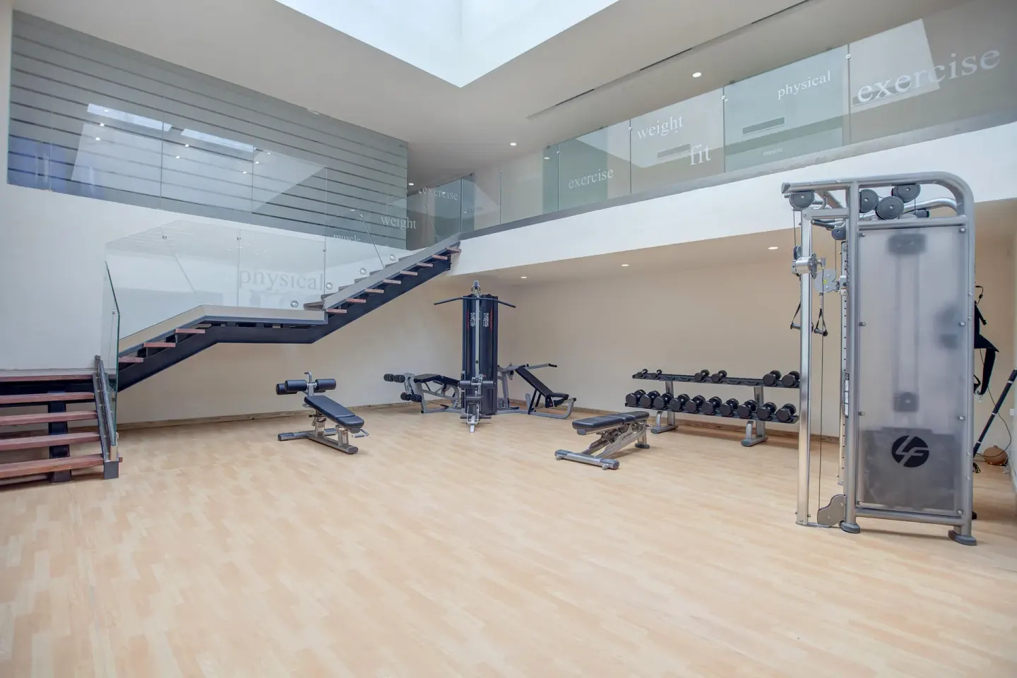 Spacious fitness center with weights and machines at Royalton Negril.