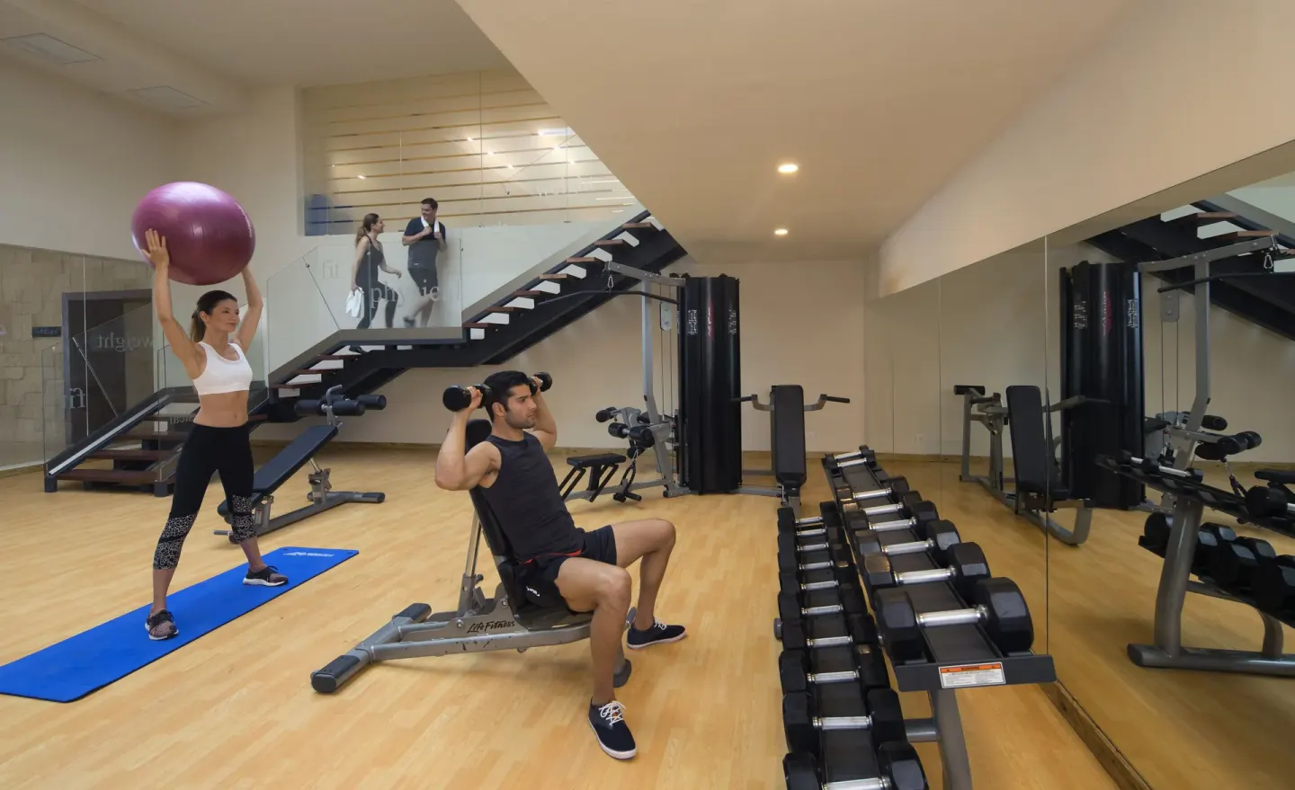 Guests exercising with free weights and a stability ball at Royalton Negril.