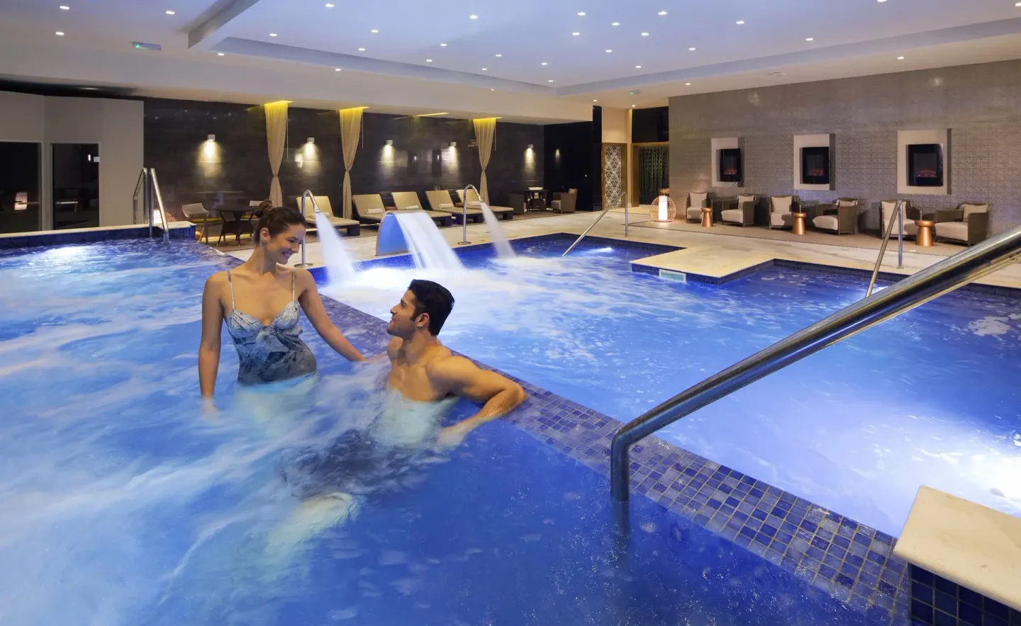 Couple stands in the indoor hydrotherapy pool at Royalton Negril.