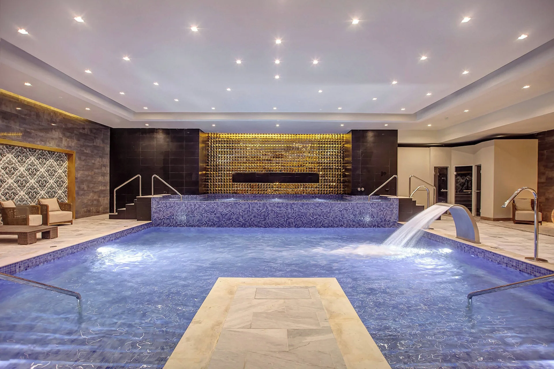Large indoor spa pool with a waterfall feature at Royalton Negril.