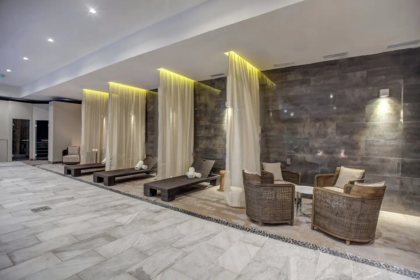Spa lounge chairs sit behind sheer curtains in a quiet area at Royalton Negril.