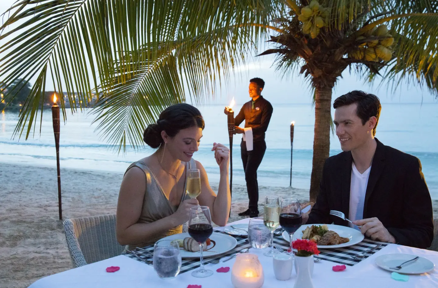 Beachfront candlelit dinner for two under palms at Royalton Negril.