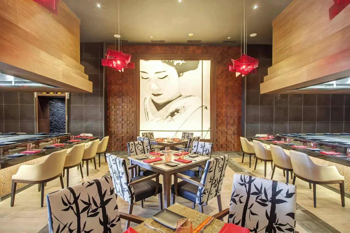 Japanese-style restaurant with sushi bars and red table accents at Royalton Negril.