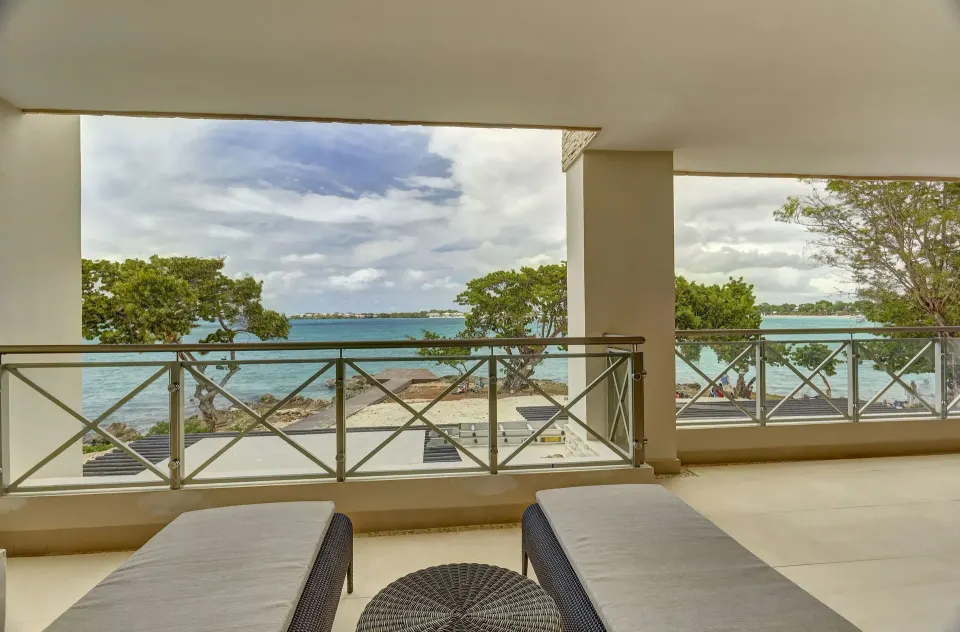 Oceanfront suite balcony with loungers and sea view at Royalton Negril.
