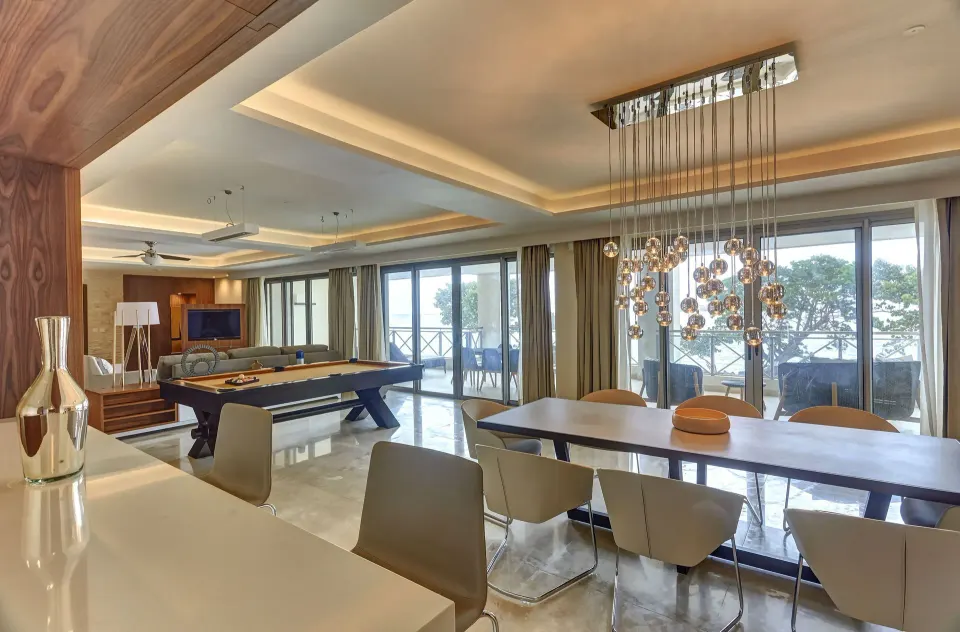 Oceanfront suite living and dining room with pool table at Royalton Negril.