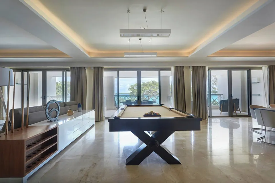 Pool table centered between balcony doors in the Chairman Two Bedroom Ocean Front Suite at Royalton Negril.