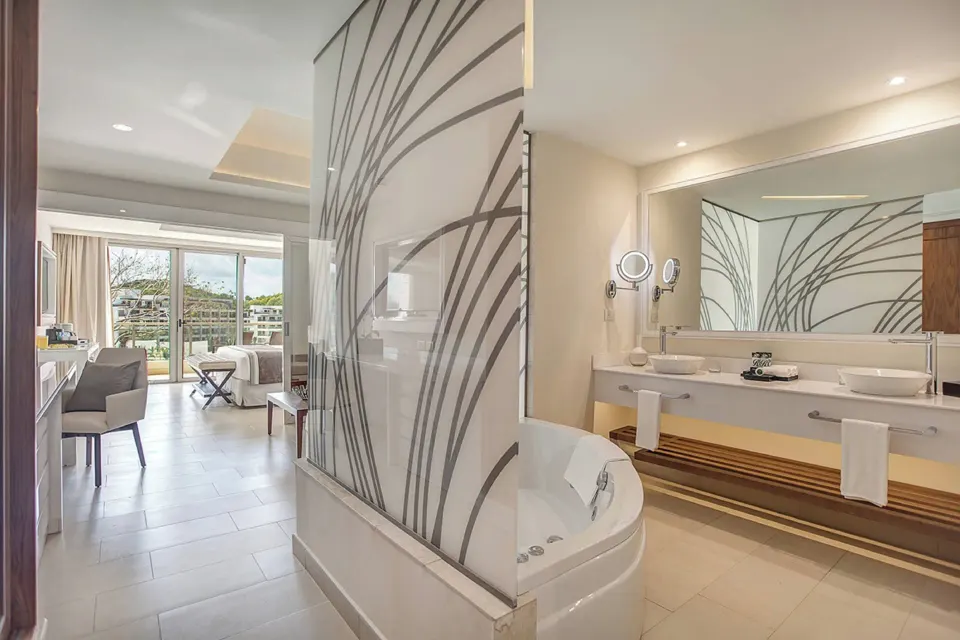 Luxury Family Suite Ocean View bathroom with tub and double vanity at Royalton Negril.