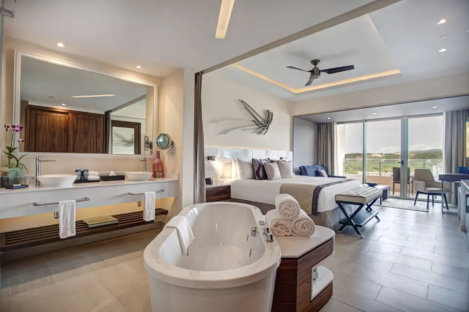 Luxury Junior Suite with king bed, soaking tub, and balcony at Royalton Negril.
