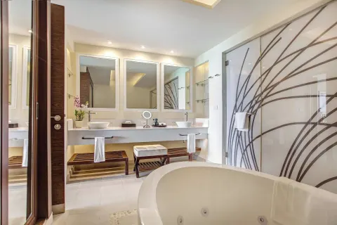 Penthouse suite bathroom with soaking tub and dual vanity at Royalton Negril.