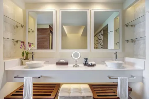 Symmetrical double vanity bathroom in a Luxury Presidential suite at Royalton Negril with bench seating.