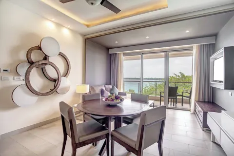 Dining table and sitting area with balcony ocean view at Royalton Negril.