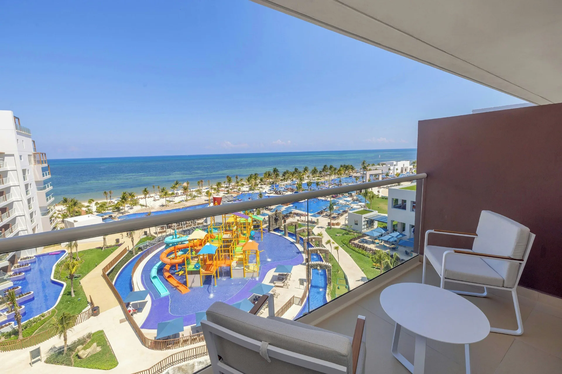 Balcony view of pools, splash area and the sea at Royalton Splash Riviera Cancun.